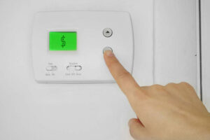 dollar sign on thermostat demonstrating how to save money