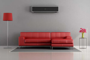 Planning to Remodel? Go Ductless! Living room with red sofa and air conditioner - 3d rendering.