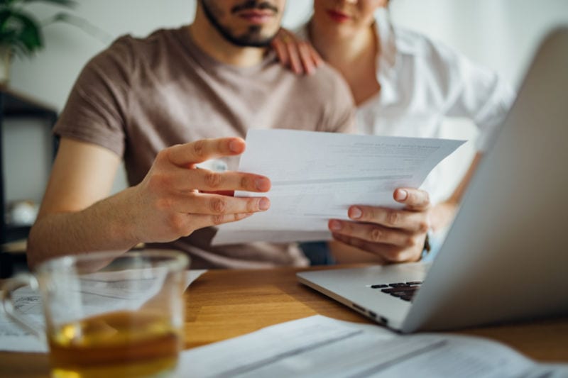 Inflation Reduction Act. Couple looking at their finances together.