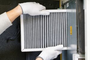4 Reasons to Replace Your Home’s Air Filter - Technician Replacing AIr FIlter.