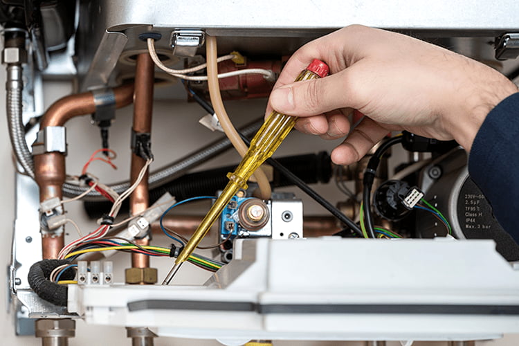 Technician Inspecting Internal Gas Furnace Components During a Maintenance Service in Mukwonago, WI